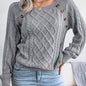 Women's sweater with puff sleeves, textured buttons, and a round neck