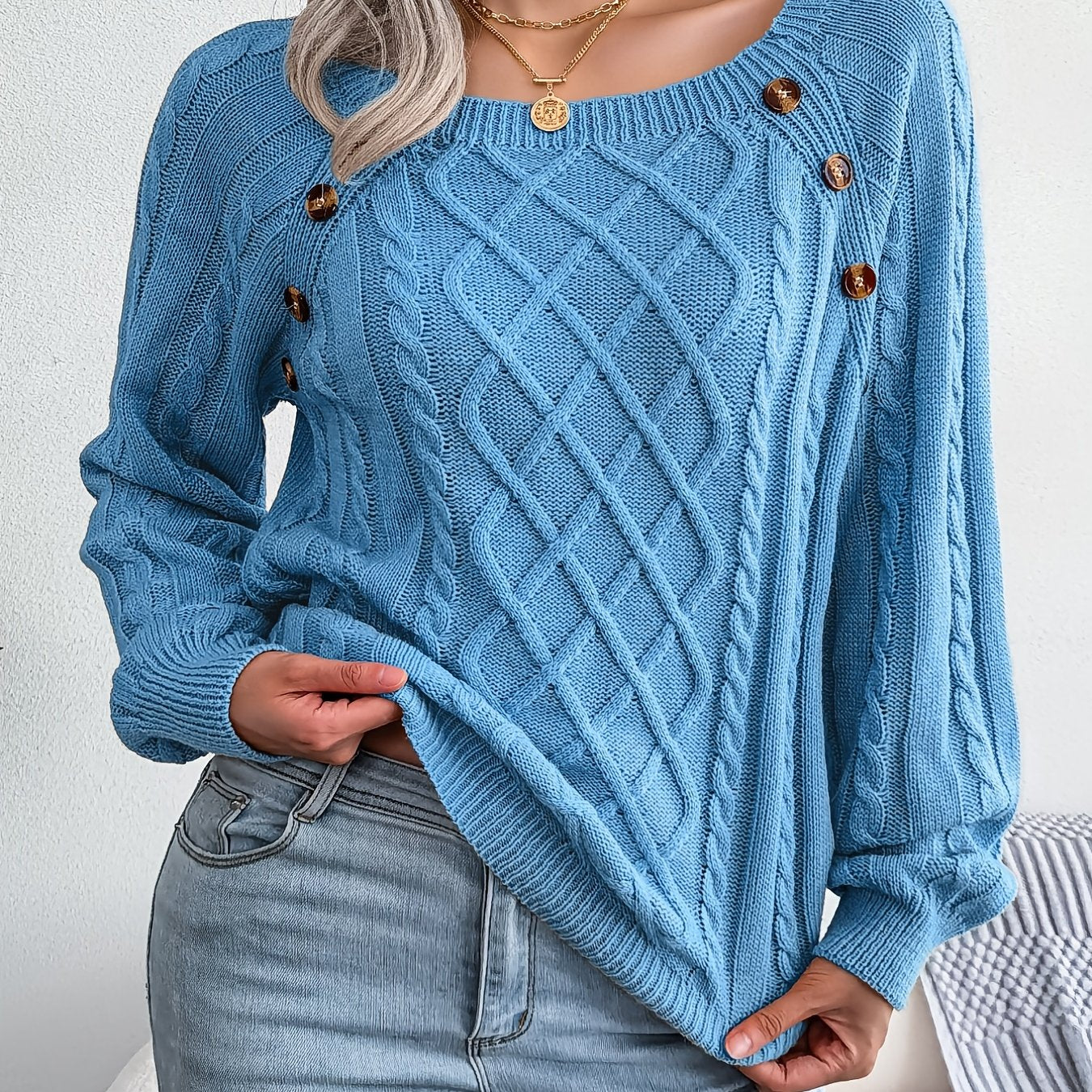 Women's sweater with puff sleeves, textured buttons, and a round neck
