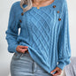 Women's sweater with puff sleeves, textured buttons, and a round neck