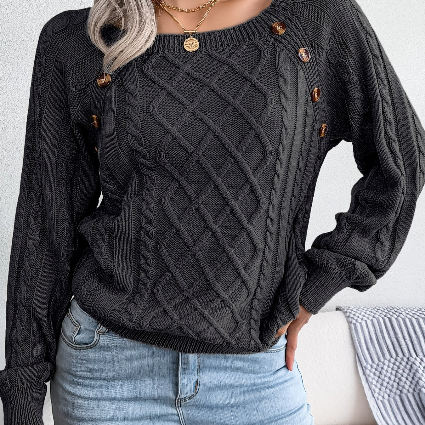 Women's sweater with puff sleeves, textured buttons, and a round neck