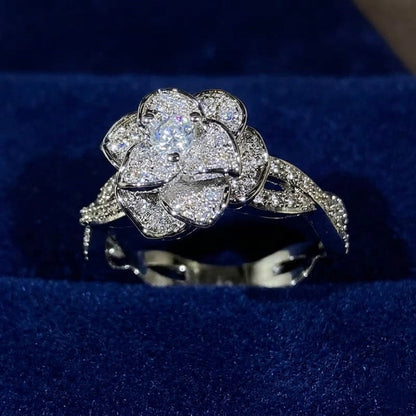 Elegant women's ring in premium 925 sterling silver featuring a three-dimensional design of intertwined roses and white cubic zirconia