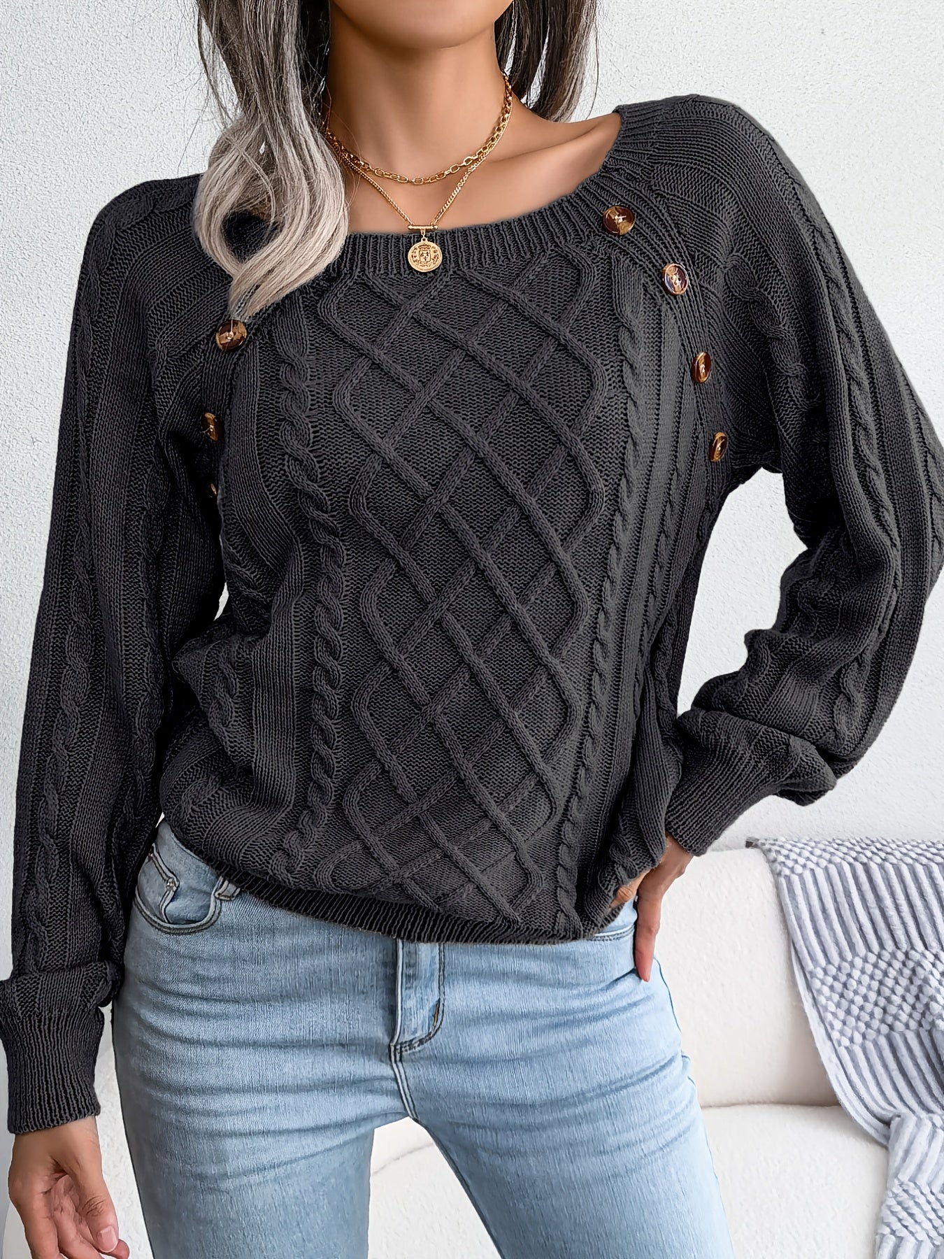 Women's sweater with puff sleeves, textured buttons, and a round neck