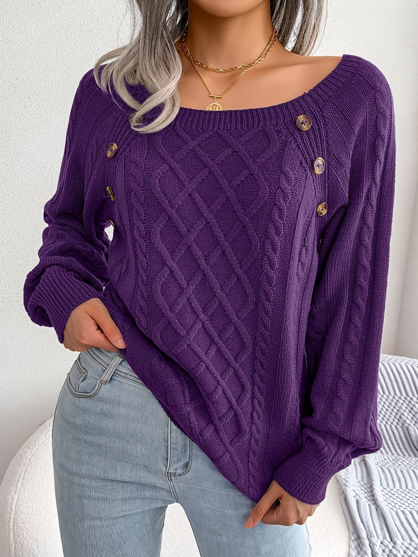 Women's sweater with puff sleeves, textured buttons, and a round neck
