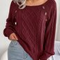 Women's sweater with puff sleeves, textured buttons, and a round neck