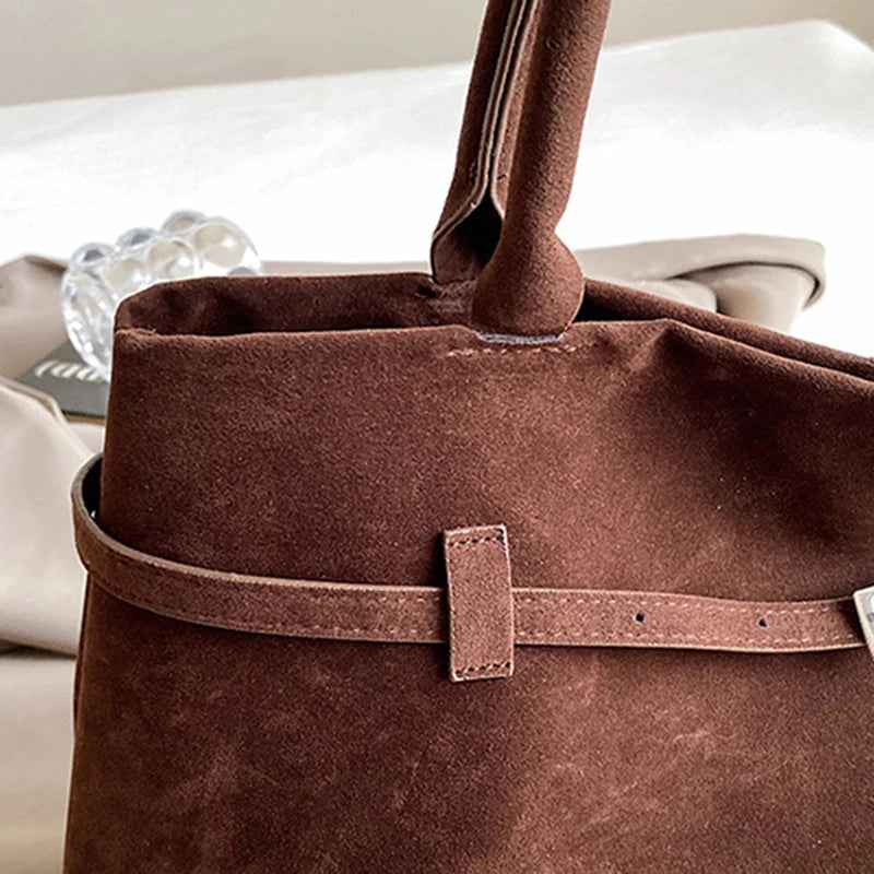 Women's handbag made of synthetic suede with a decorative buckle, large capacity, and snap closure