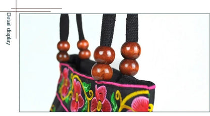 Small women's shoulder bag with floral embroidery, top handle, and flap with bead embellishments
