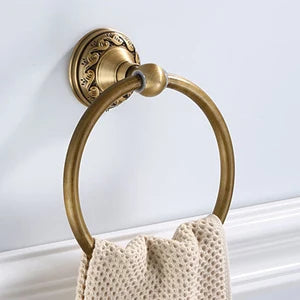 Round aluminum wall-mounted towel rack for bathrooms, with an antique brass finish.