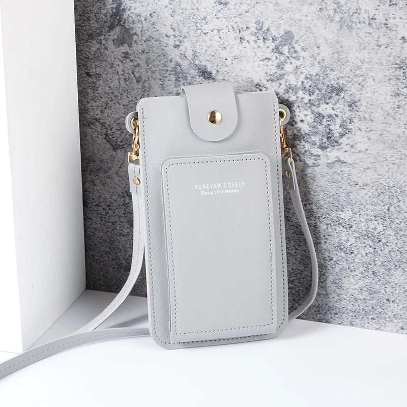 Modern shoulder bag in a solid color, with compartments for cell phone, wallets, and document holder