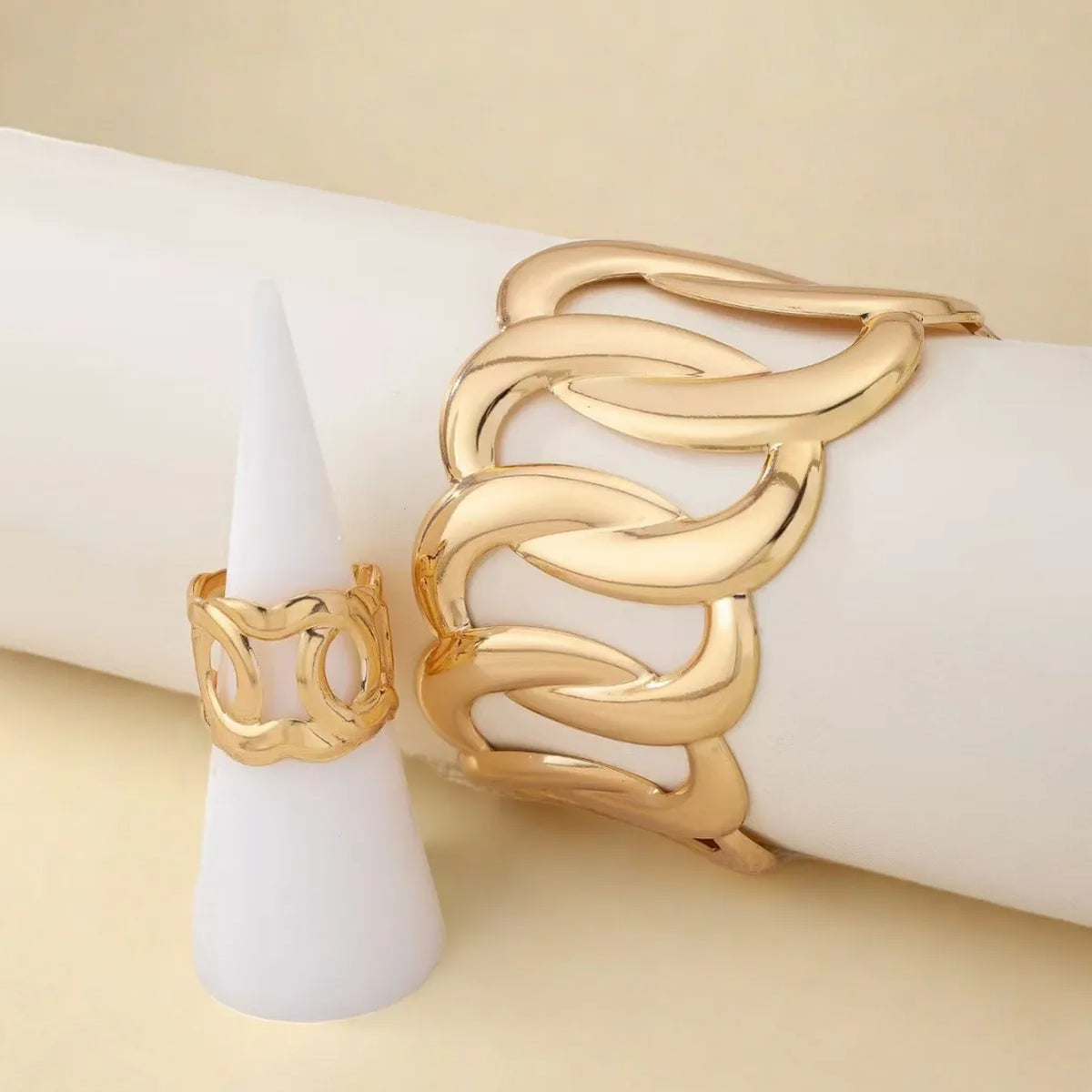 Bracelet and ring set with a geometric design of intertwined and sinuous links, with an adjustable opening