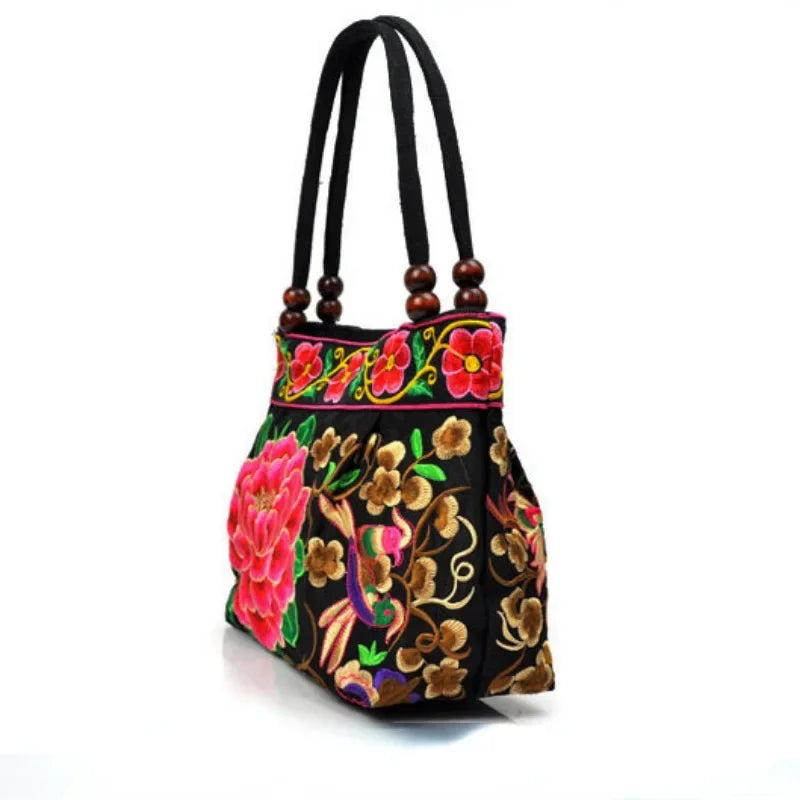 Small women's shoulder bag with floral embroidery, top handle, and flap with bead embellishments