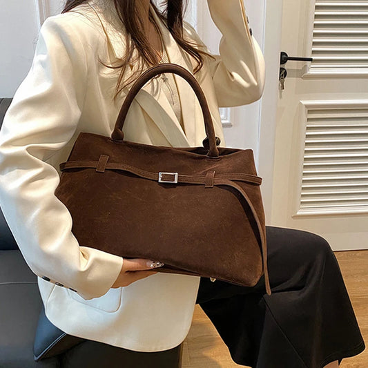 Women's handbag made of synthetic suede with a decorative buckle, large capacity, and snap closure