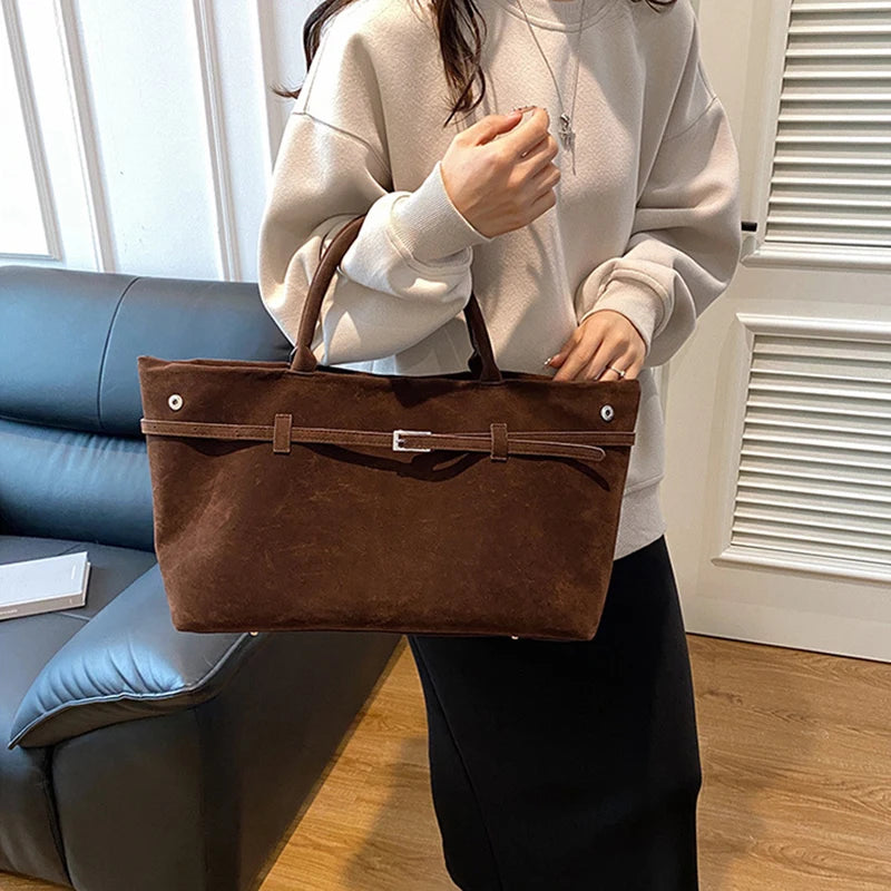 Women's handbag made of synthetic suede with a decorative buckle, large capacity, and snap closure