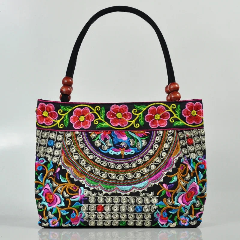 Small women's shoulder bag with floral embroidery, top handle, and flap with bead embellishments
