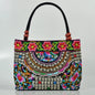 Small women's shoulder bag with floral embroidery, top handle, and flap with bead embellishments