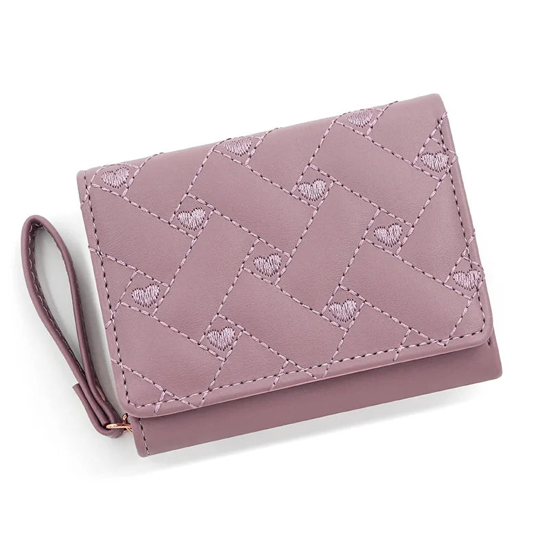 Small women's wallet in leather, elegant design, available in various colors.