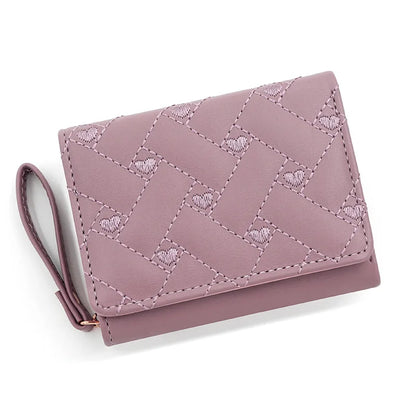 Small women's wallet in leather, elegant design, available in various colors.