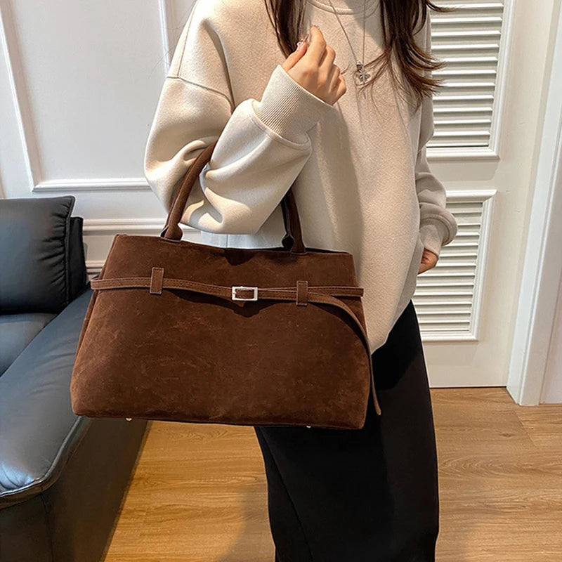 Women's handbag made of synthetic suede with a decorative buckle, large capacity, and snap closure