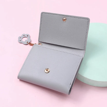 Small and compact women's wallet for girls with a cat print, featuring card slots and a bill compartment.