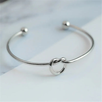 Women's rigid stainless steel bracelet with knot detail