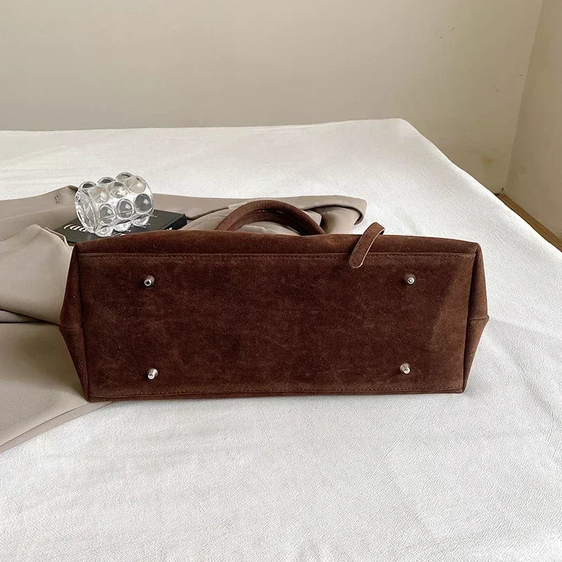 Women's handbag made of synthetic suede with a decorative buckle, large capacity, and snap closure