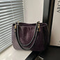 Women's satchel and tote bag with crocodile print and top handle. Stylish