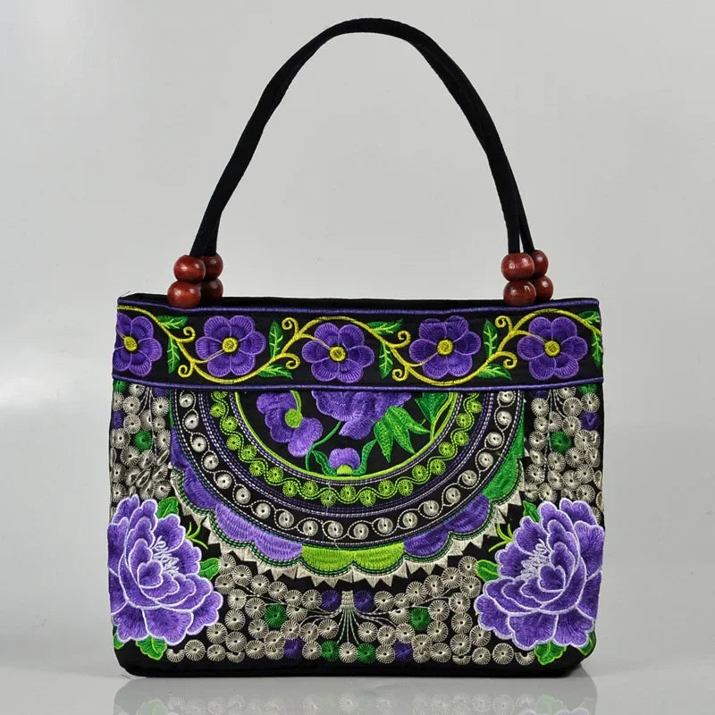 Small women's shoulder bag with floral embroidery, top handle, and flap with bead embellishments