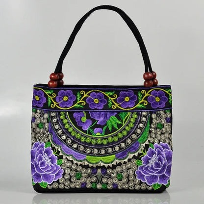 Small women's shoulder bag with floral embroidery, top handle, and flap with bead embellishments