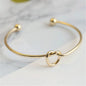 Women's rigid stainless steel bracelet with knot detail