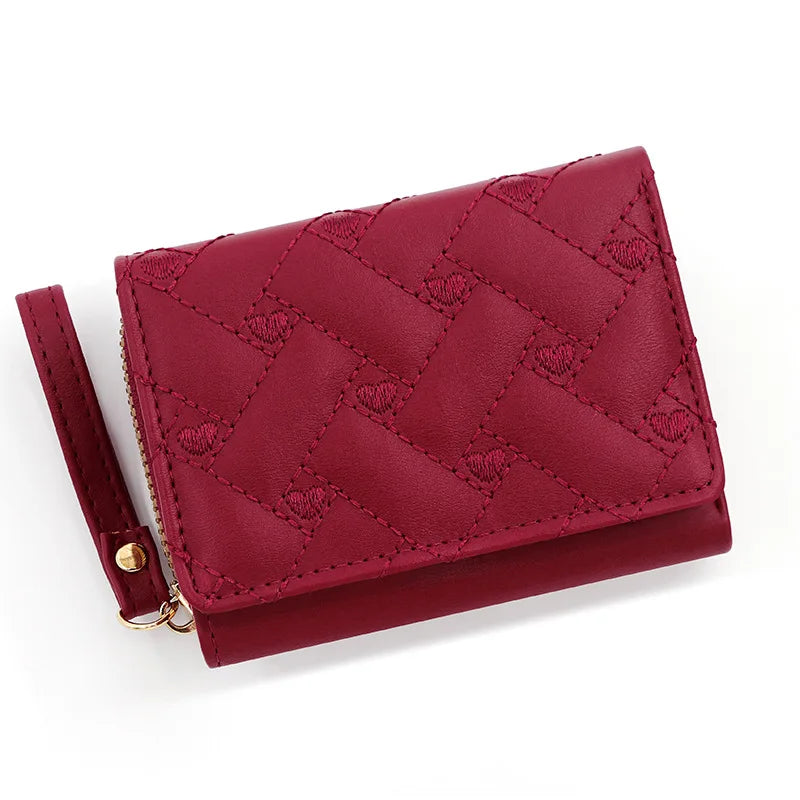 Small women's wallet in leather, elegant design, available in various colors.