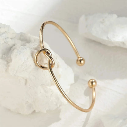 Women's rigid stainless steel bracelet with knot detail