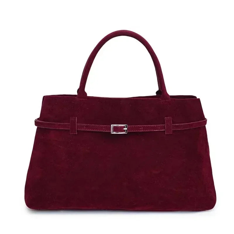 Women's handbag made of synthetic suede with a decorative buckle, large capacity, and snap closure