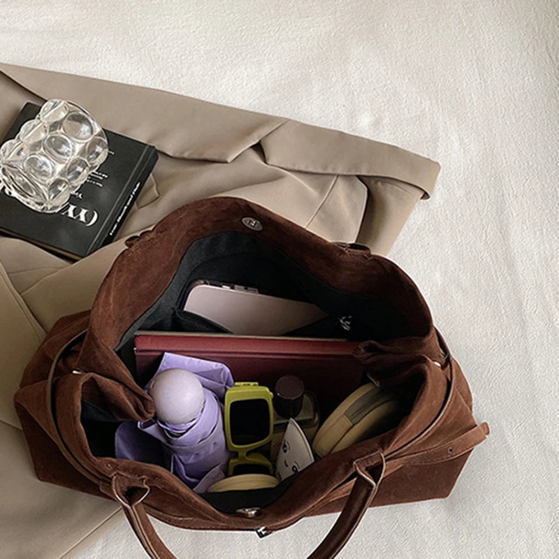 Women's handbag made of synthetic suede with a decorative buckle, large capacity, and snap closure