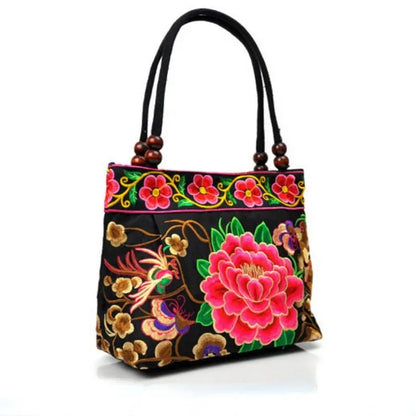 Small women's shoulder bag with floral embroidery, top handle, and flap with bead embellishments