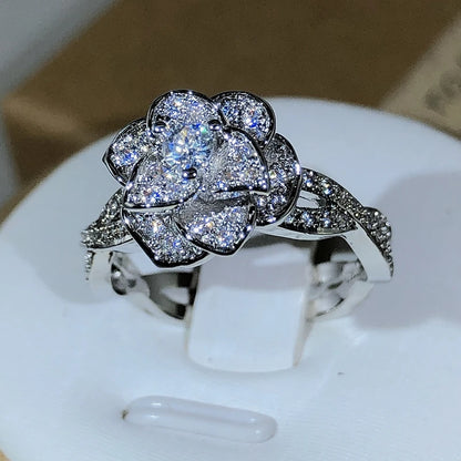 Elegant women's ring in premium 925 sterling silver featuring a three-dimensional design of intertwined roses and white cubic zirconia
