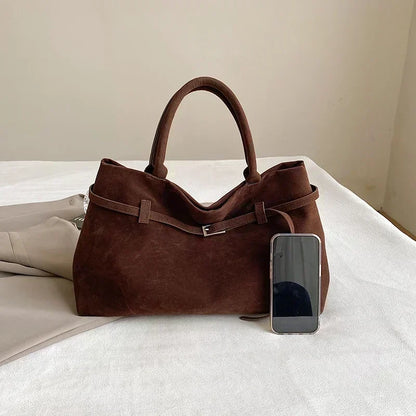 Women's handbag made of synthetic suede with a decorative buckle, large capacity, and snap closure