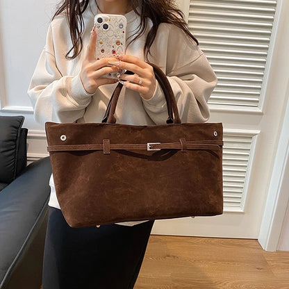 Women's handbag made of synthetic suede with a decorative buckle, large capacity, and snap closure
