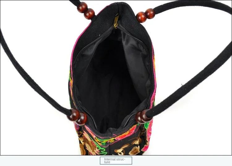 Small women's shoulder bag with floral embroidery, top handle, and flap with bead embellishments