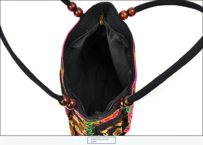 Small women's shoulder bag with floral embroidery, top handle, and flap with bead embellishments