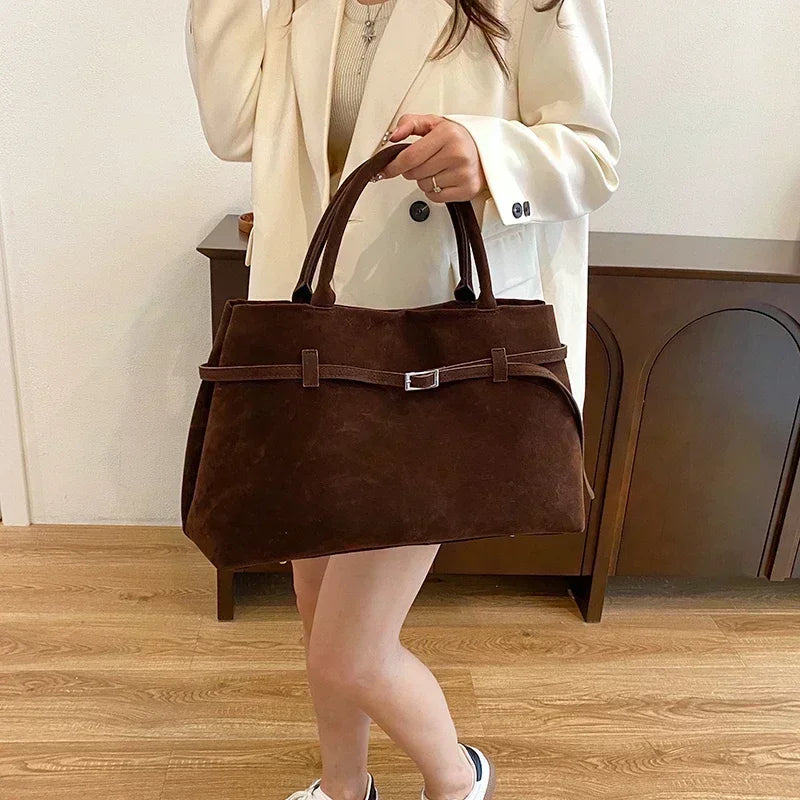 Women's handbag made of synthetic suede with a decorative buckle, large capacity, and snap closure