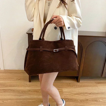 Women's handbag made of synthetic suede with a decorative buckle, large capacity, and snap closure