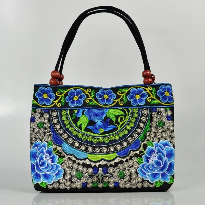 Small women's shoulder bag with floral embroidery, top handle, and flap with bead embellishments