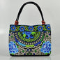 Small women's shoulder bag with floral embroidery, top handle, and flap with bead embellishments