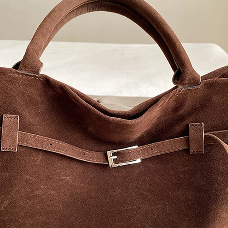 Women's handbag made of synthetic suede with a decorative buckle, large capacity, and snap closure