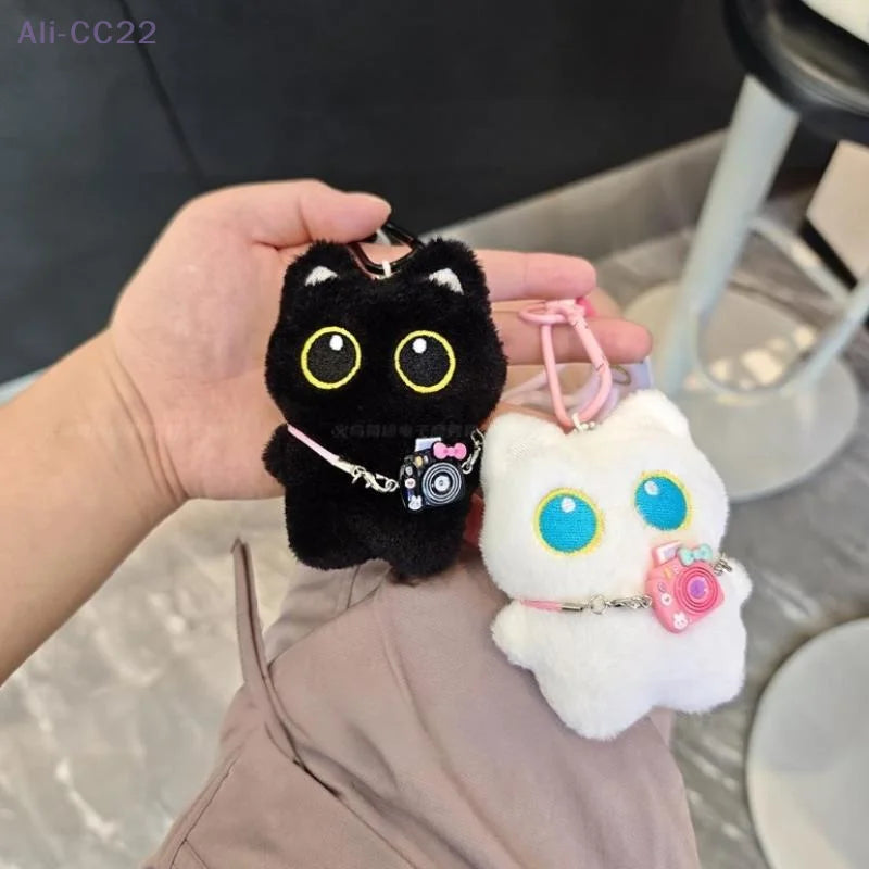 Black and white kitten keychain with big, cute eyes, cartoon plush pendant