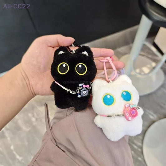 Black and white kitten keychain with big, cute eyes, cartoon plush pendant