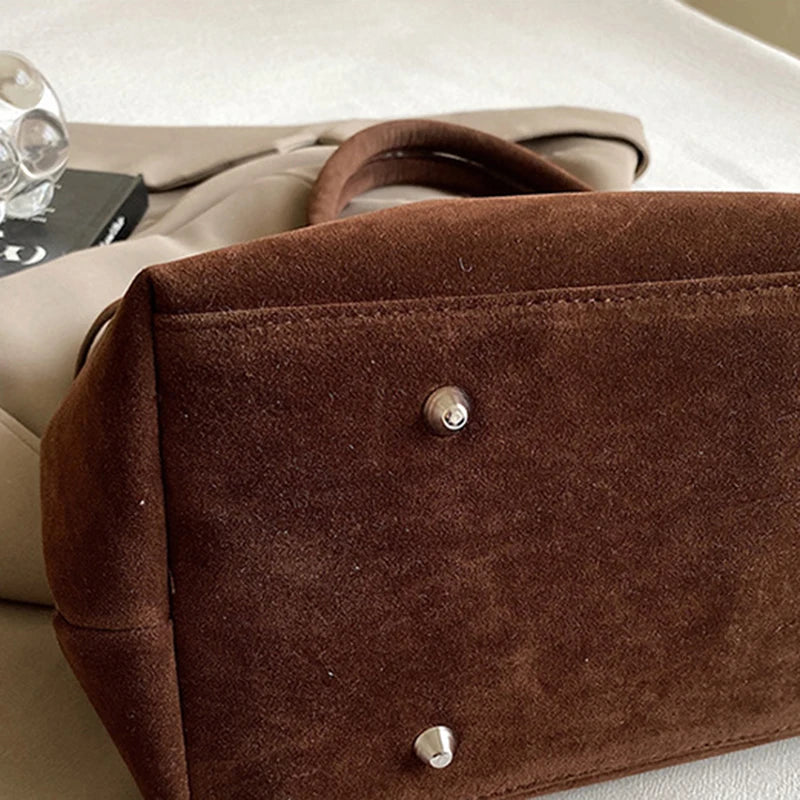 Women's handbag made of synthetic suede with a decorative buckle, large capacity, and snap closure