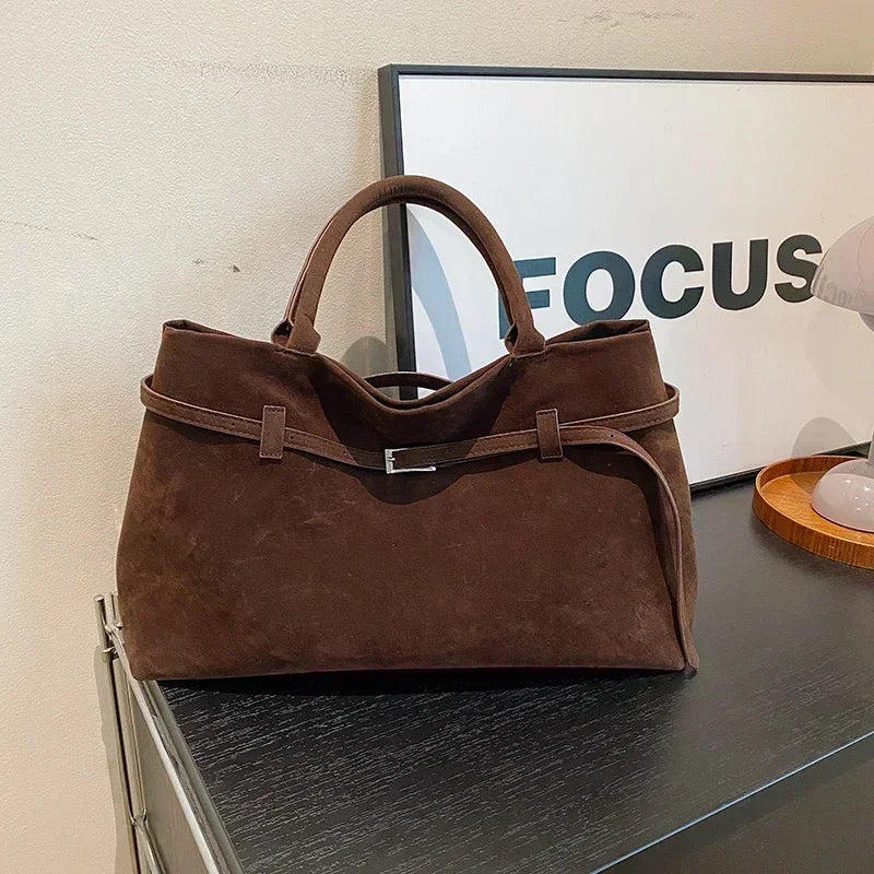 Women's handbag made of synthetic suede with a decorative buckle, large capacity, and snap closure
