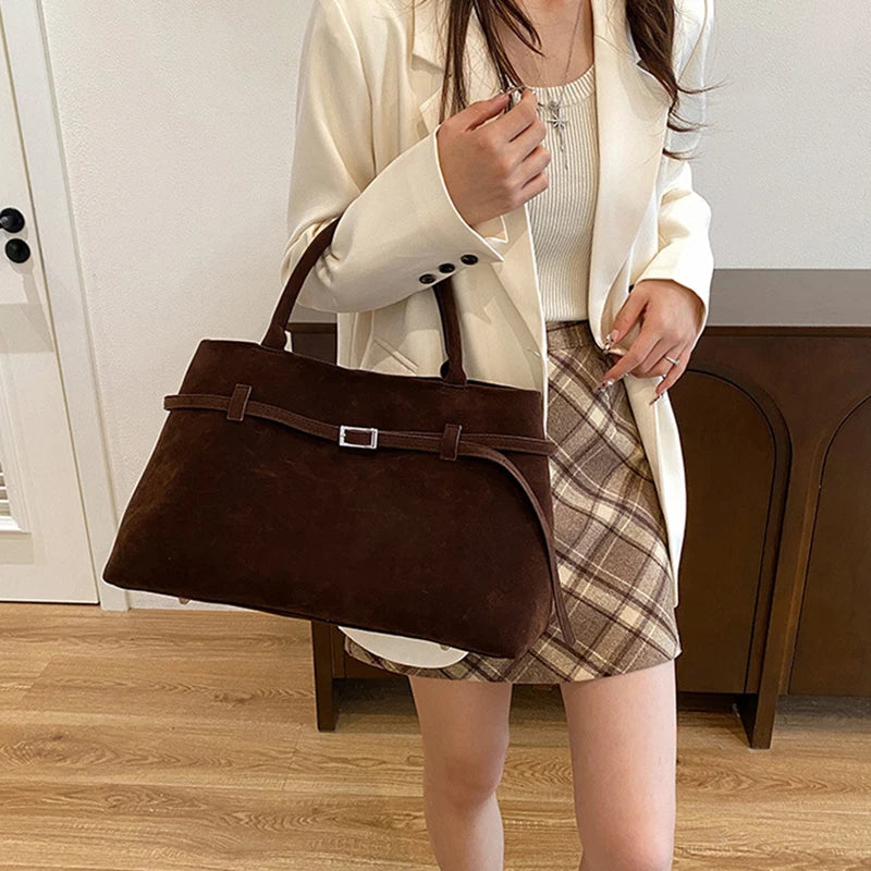 Women's handbag made of synthetic suede with a decorative buckle, large capacity, and snap closure