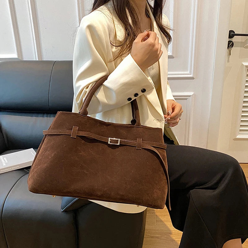 Women's handbag made of synthetic suede with a decorative buckle, large capacity, and snap closure