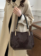 Women's satchel and tote bag with crocodile print and top handle. Stylish